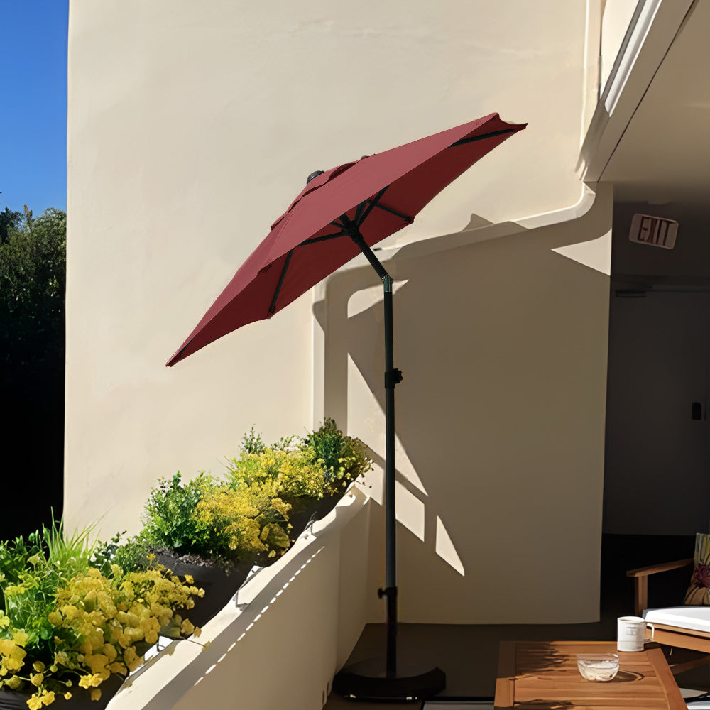 A charming balcony with an AMMSUN red small patio umbrella for apartment and rustic wooden furniture