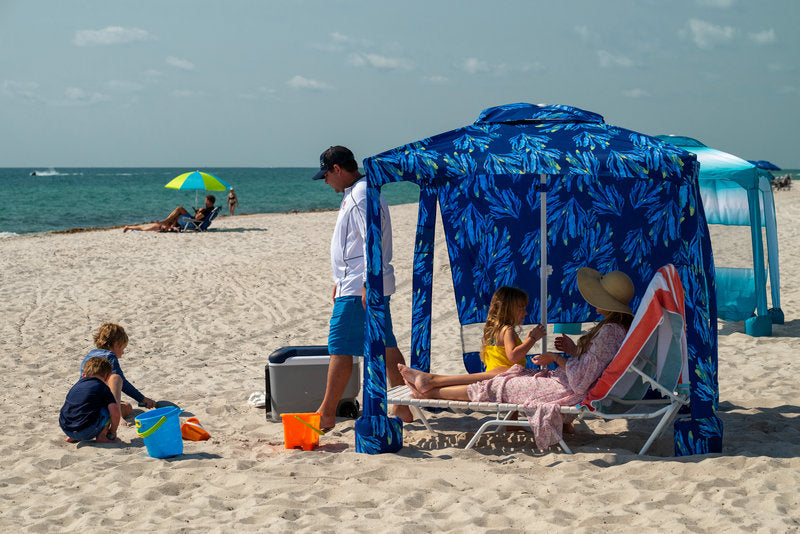 A family enjoying beachday with AMMSUN beach canopy cabana with privacy wall for beach tent