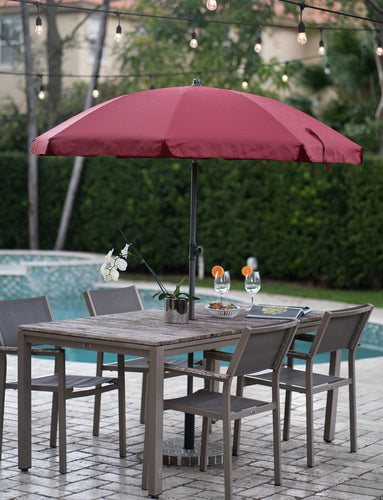 An AMMSUN red patio umbrella for outside umbrella shades a table with chairs beside pool