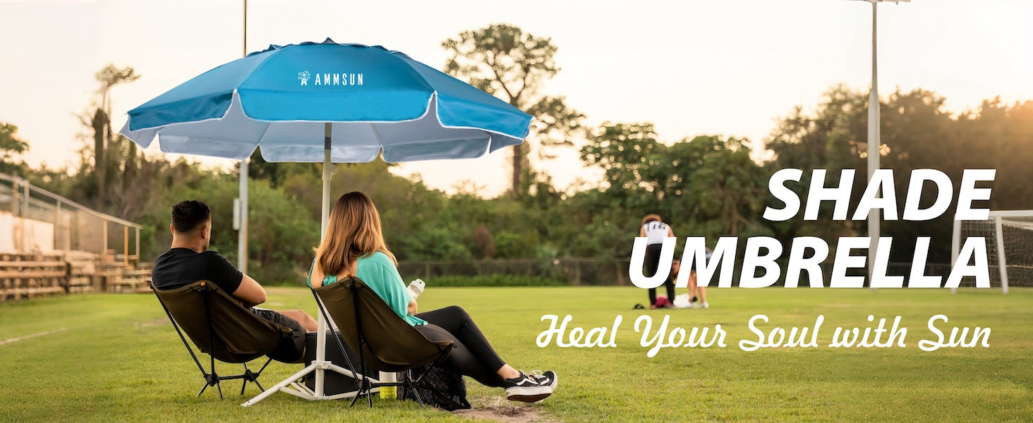 Two people sitting under AMMSUN 6.5ft sky blue sports umbrella with stand on grass