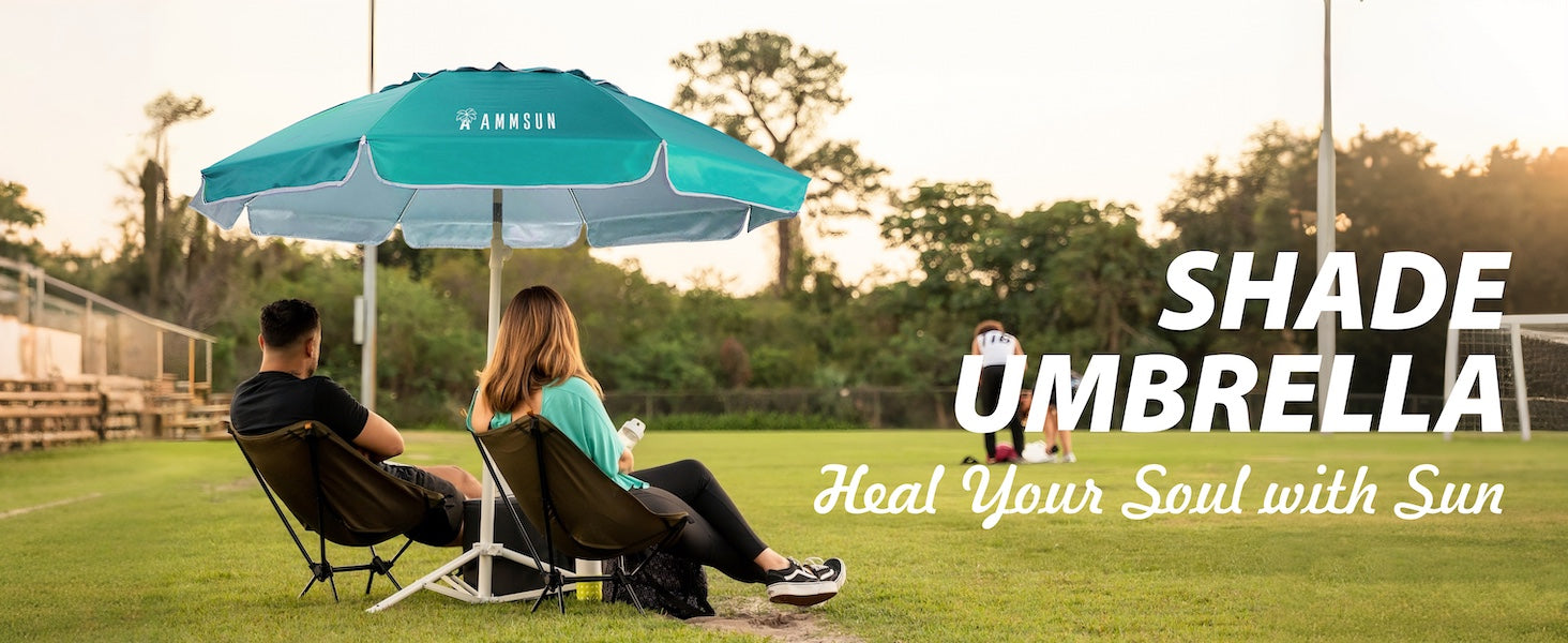 Two people sitting under an AMMSUN 6.5ft turquoise portable outdoor umbrella with base for soccer game 