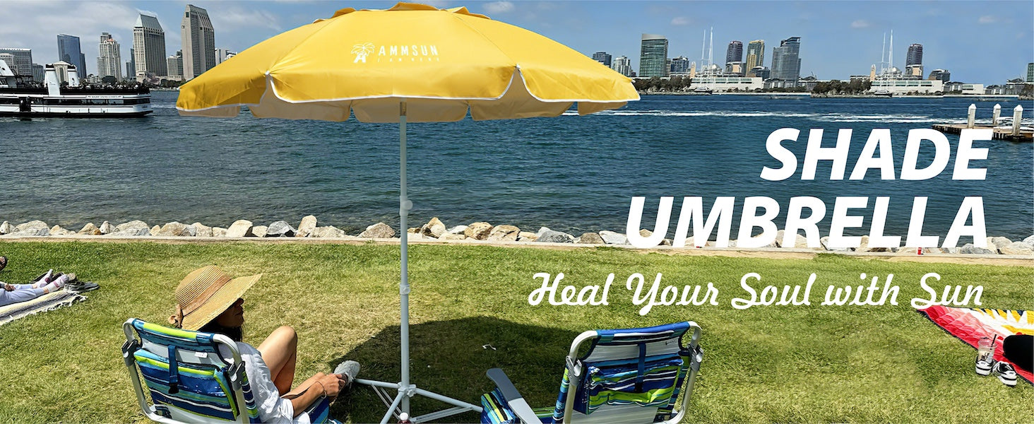 A woman sitting under AMMSUN 6.5ft yellow outdoor umbrella with base outdoor umbrella stand