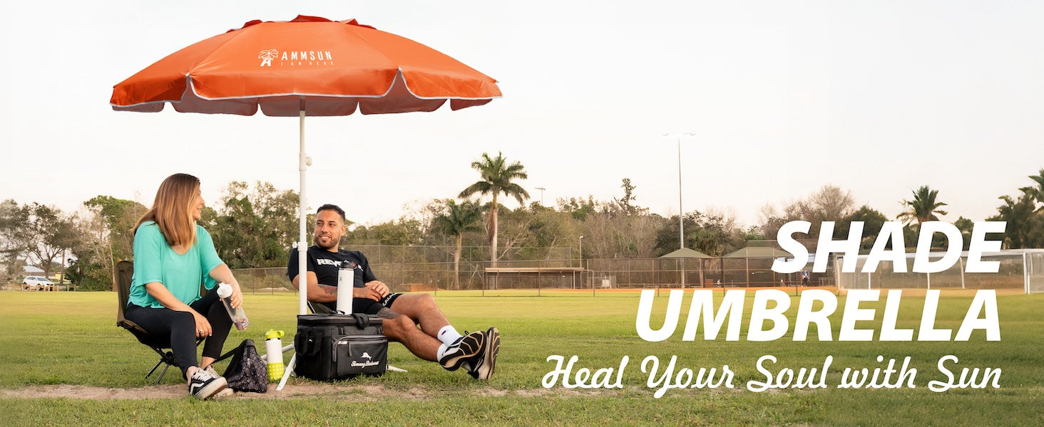 Two people sitting under an AMMSUN 6.5ft orange  sports umbrella portable umbrella with stand for sport games