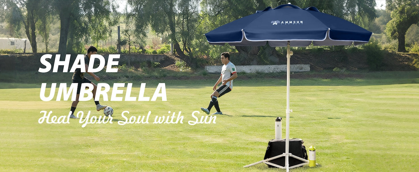 Two men playing football with AMMSUN 6.5ft dark blue portable outdoor umbrella with base next to them.