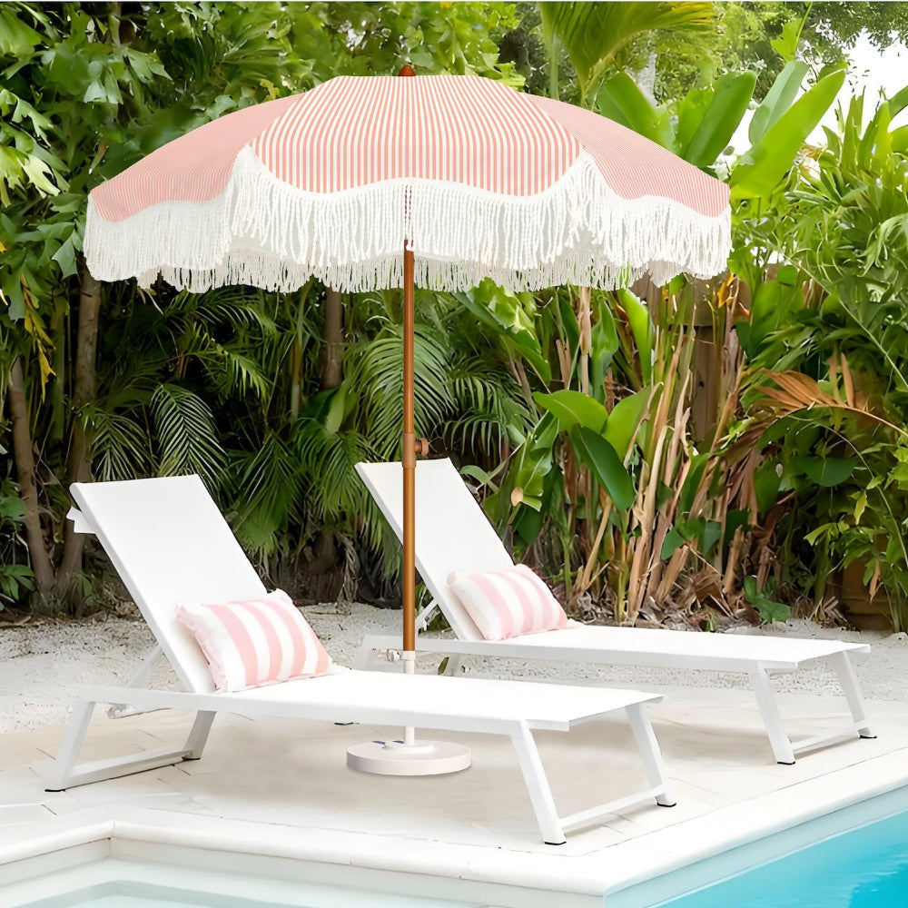White lounge chairs with AMMSUN 6.5ft boho fringe backyard umbrella for outdoor with tassel by a poolside.