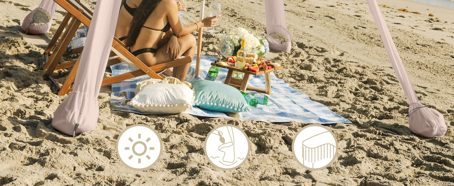 Two women relaxing under an AMMSUN 7'x7' Pink Coral coolcabana beach tent with fringe boho beach cabana with premium wood pole