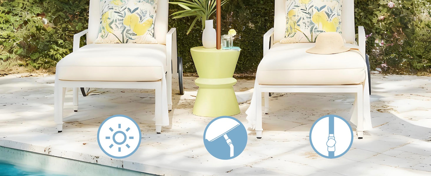 Two white chairs with yellow cushions on a wooden deck by a pool, with a green side table.