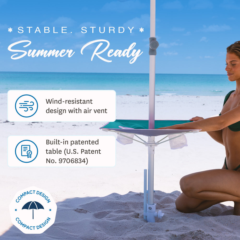 A woman using the convenient table mounted on a patented windproof AMMSUN teal umbrella. Beach umbrella with table, Tommy bahama beach umbrella