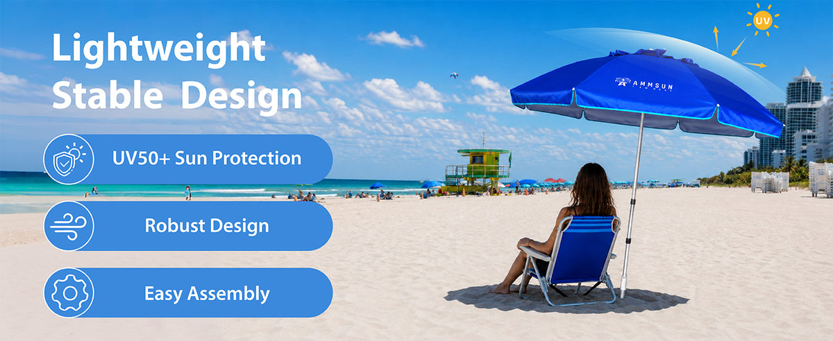 A woman sitting under an AMMSUN blue 6.5ft portable folding travle beach umbrella on sandy beach