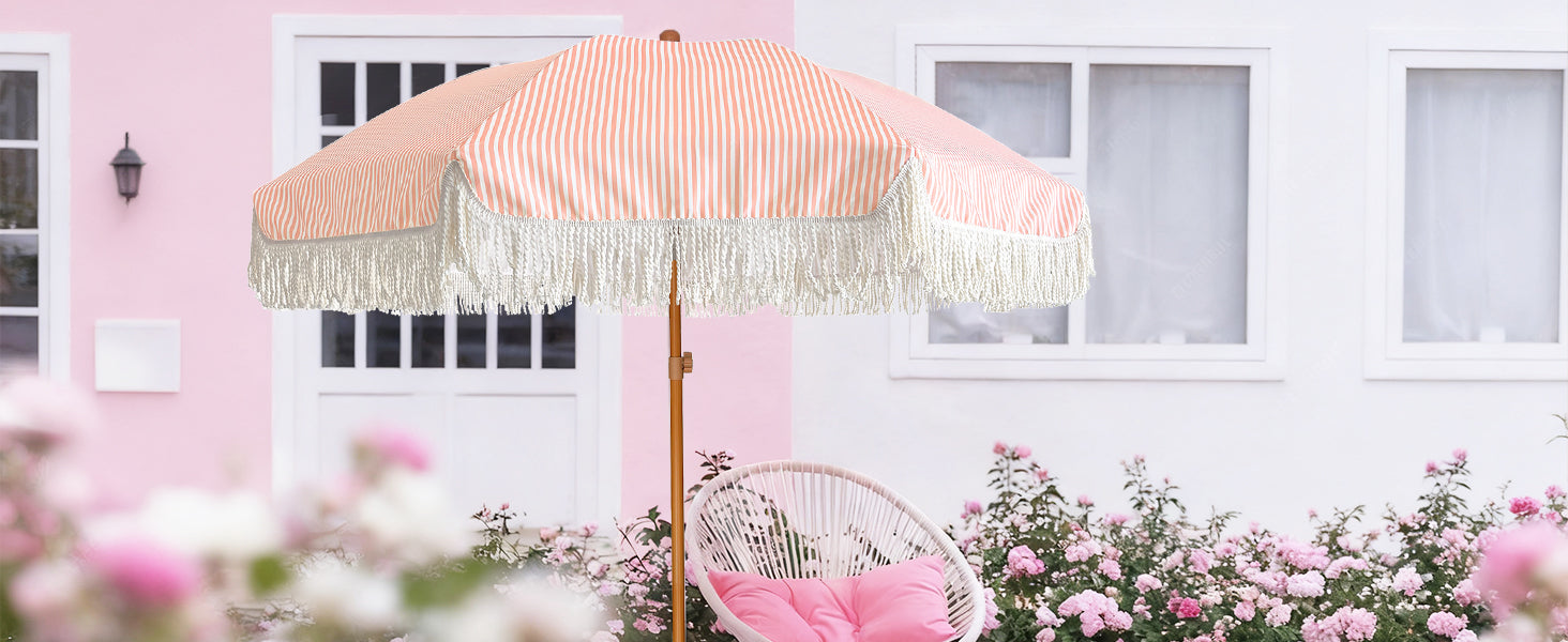A chair under an AMMSUN pink beach umbrellas for sand with fringe boho umbrella for patio