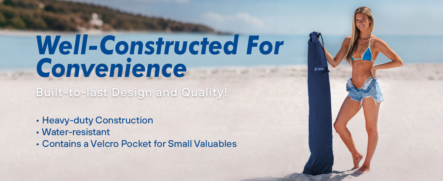 A woman stands on the beach, with an umbrella in umbrella stroller travel bag