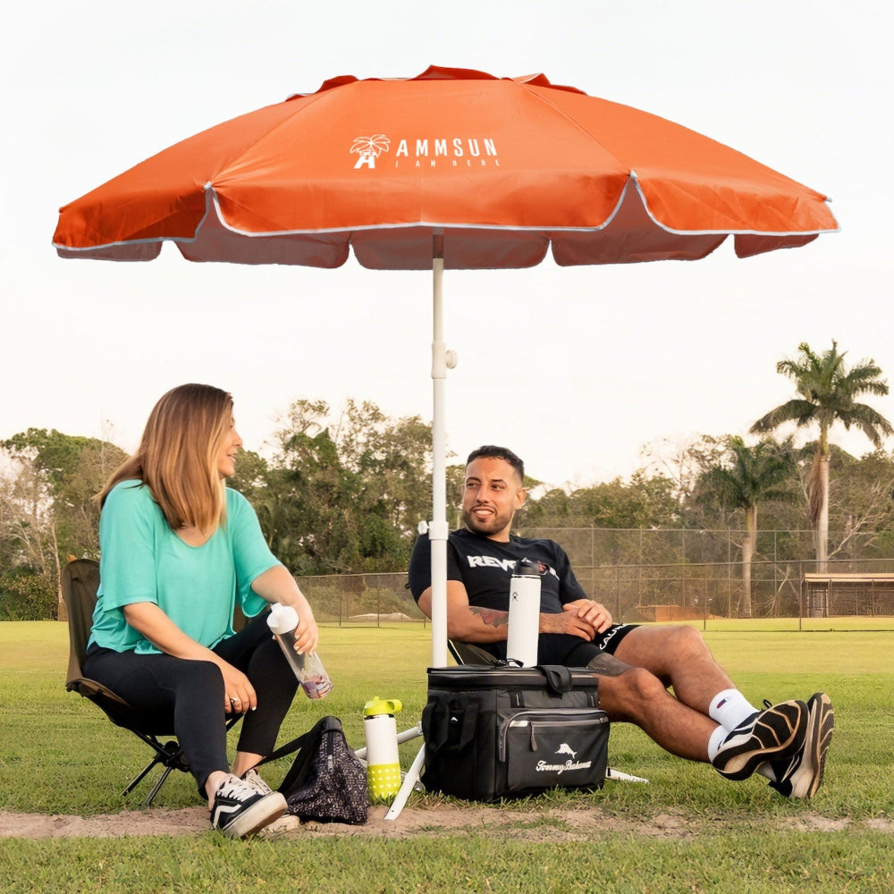 Two people sitting under an AMMSUN 6.5ft orange portable umbrella for outside umbrella on a field, providing patio shades
