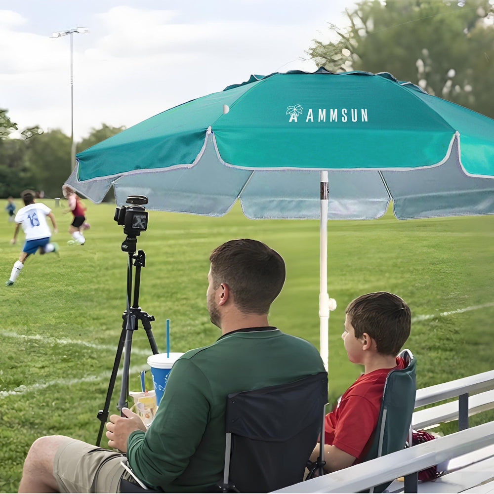 Man and child sitting under an AMMSUN 6.5ft turquoise portable beach umbrellas with satnd, watching a sports game