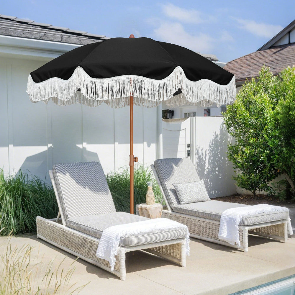 Two chairs with a black AMMSUN 6.5ft boho fringe backyard umbrella for outdoor with tassel by poolside