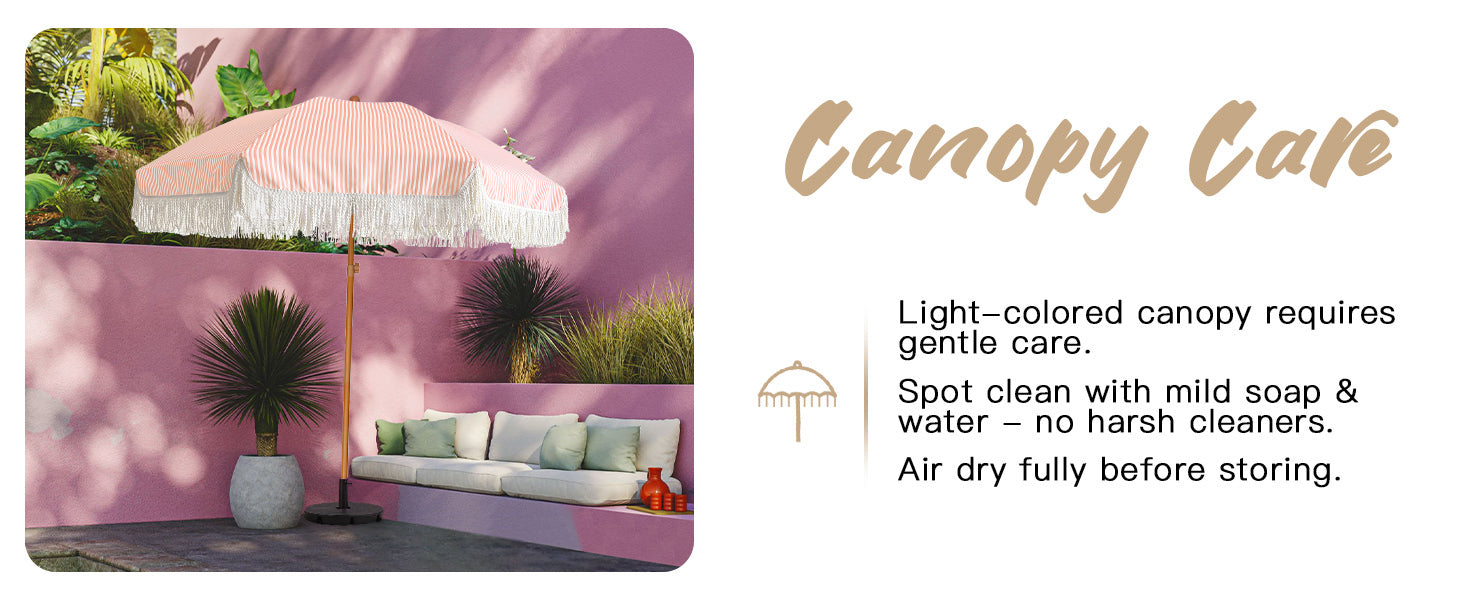 A pink wall showcases a pink wedding umbrella with fringe for outdoor umbrellas for patio