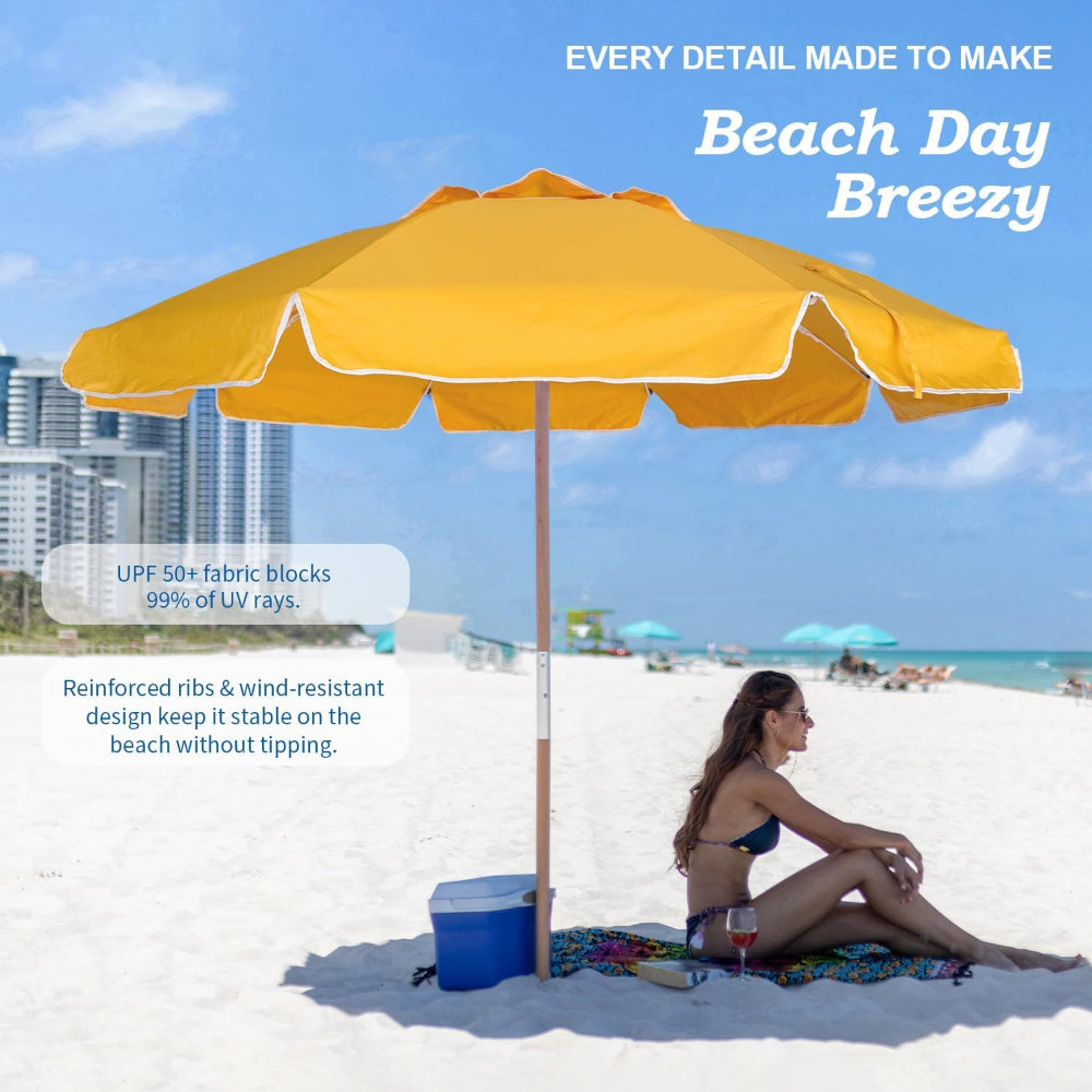 A woman sitting under Ammsun 7.5ft yellow commercial grade portable beach umbrella on beach