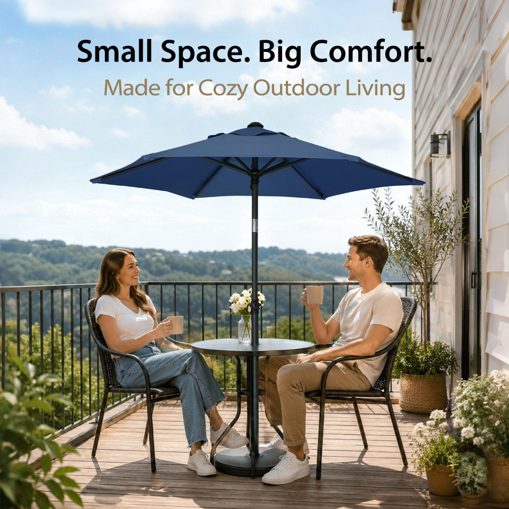 Two people sitting under an AMMSUN 6ft dark blue sombrillas para patio for Deck