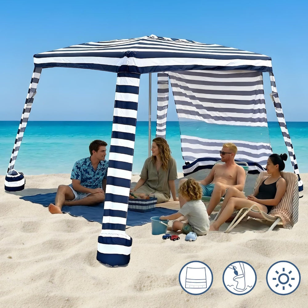 A family of 5 relaxing under an AMMSUN 8'x8' navy blue stripe extra large beach tent cabana portable with side wall umbrella on sand