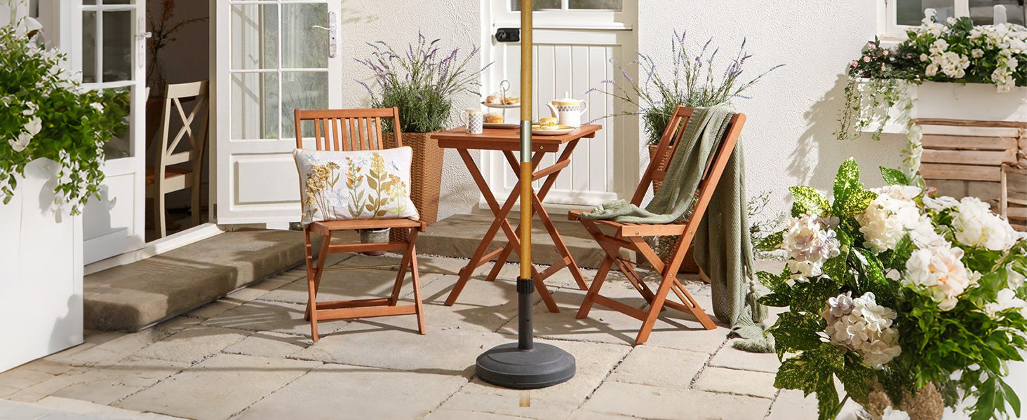 Outdoor patio setting with wooden chairs, table, and decorative elements on a stone patio.