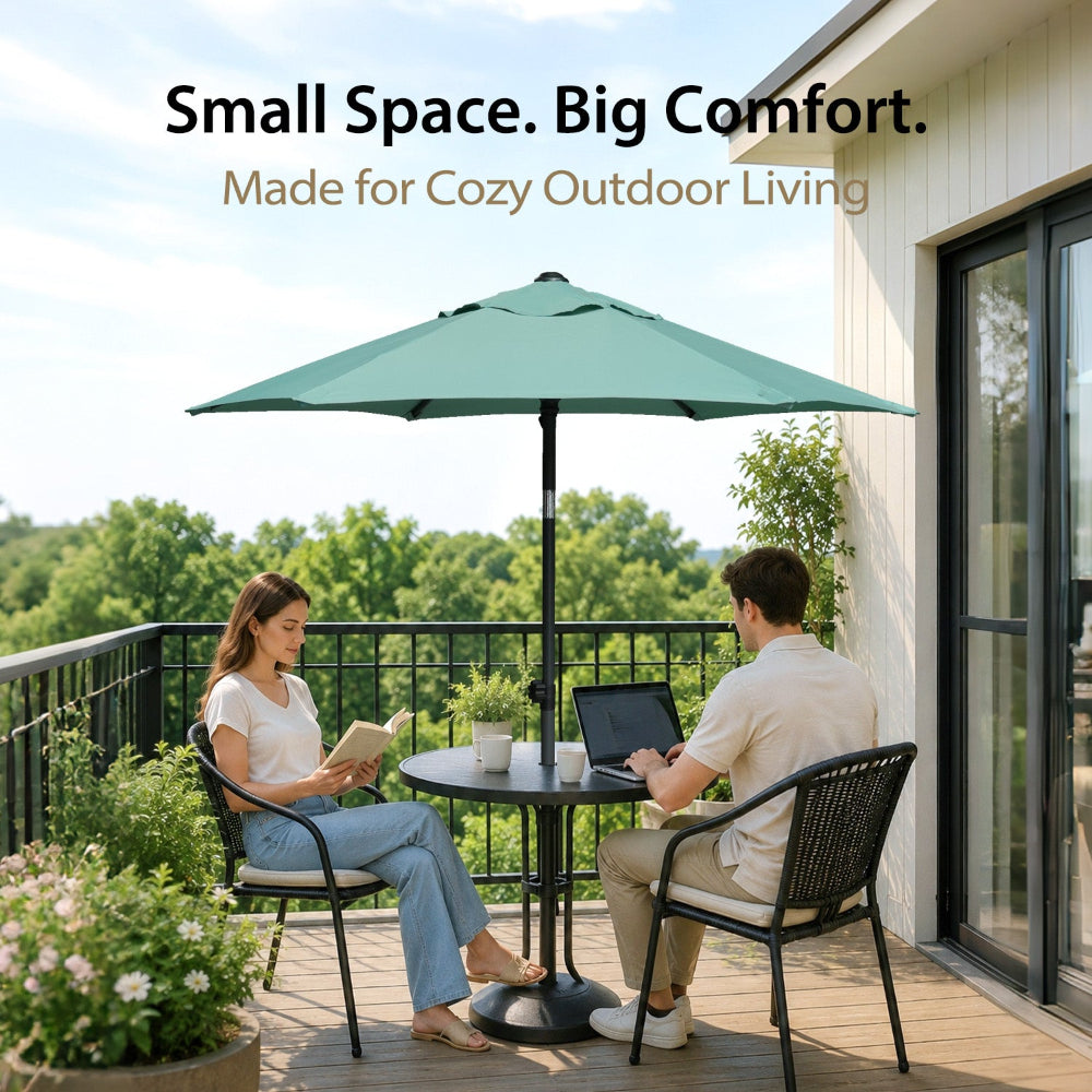 Two people sitting with a table, and an AMMSUN 6ft green umbrellas for sun protection umbrella on balcony