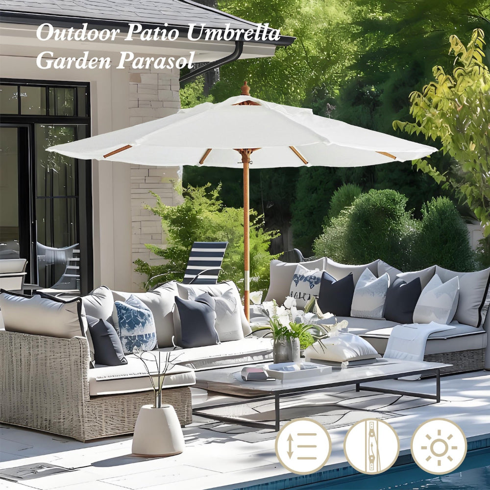 Outdoor patio with a large white chair umbrella with pulley lift wooden handle umbrella, and chairs.