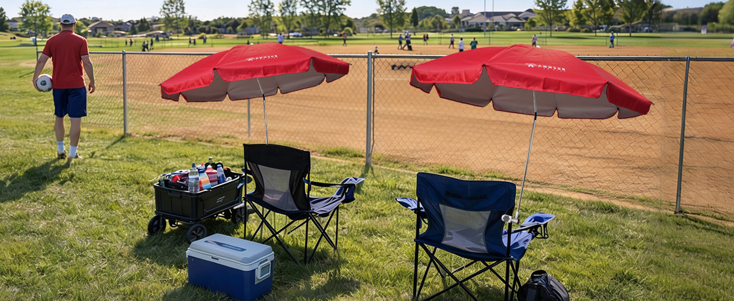 Two chairs with AMMSUN red 47inches umbrella chairs for adults with clamp are placed on the soccor field