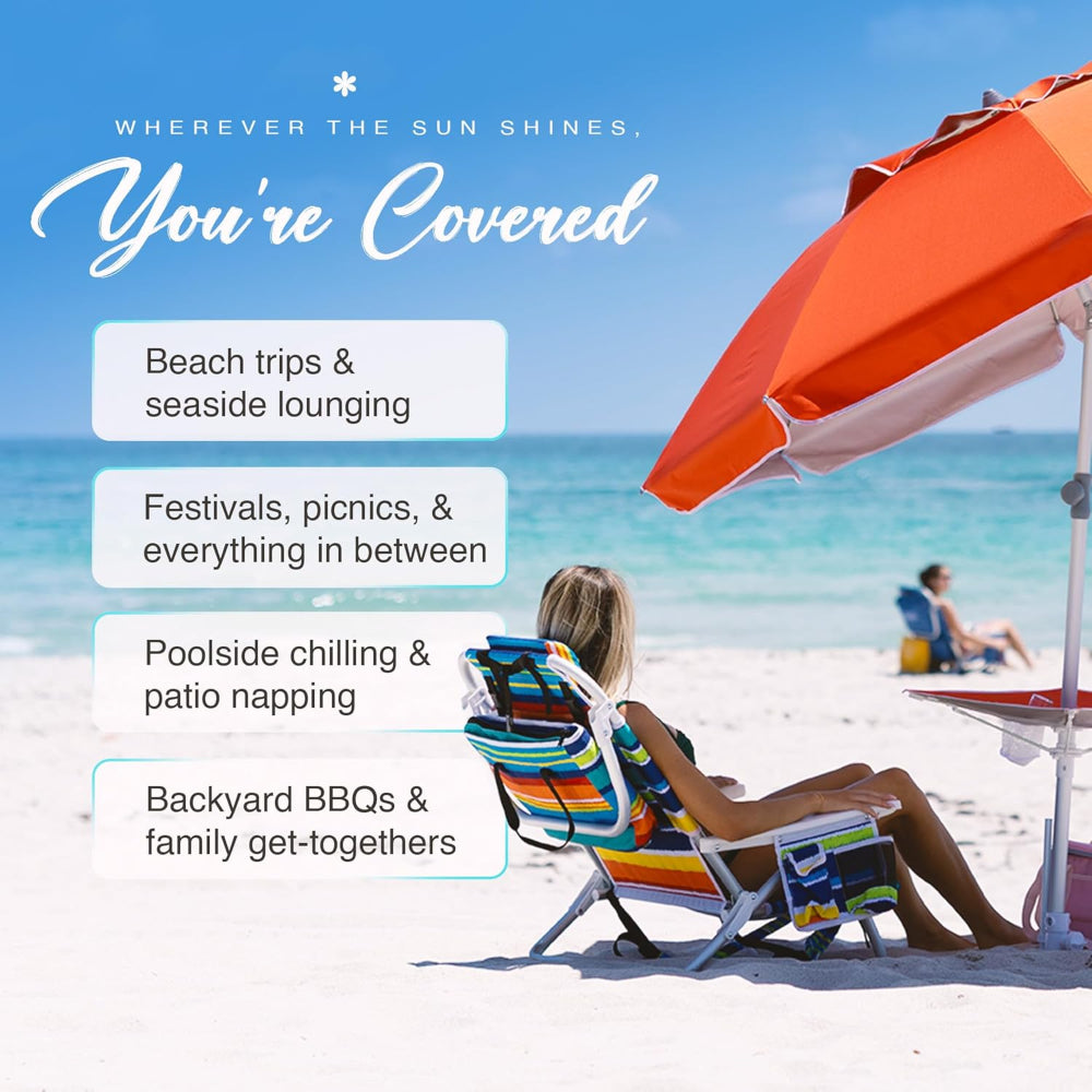 A woman sitting under the AMMSUN solid red 7ft beach umbrellas for sand heavy duty wind portable with table tray