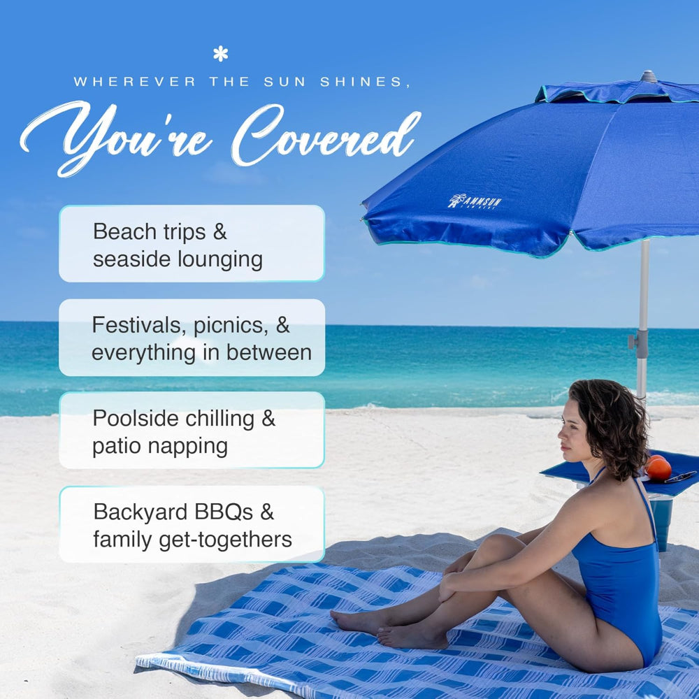 A woman is having fun under AMMSUN blue 7ft wind resistant beach umbrella with sand anchor and table tray