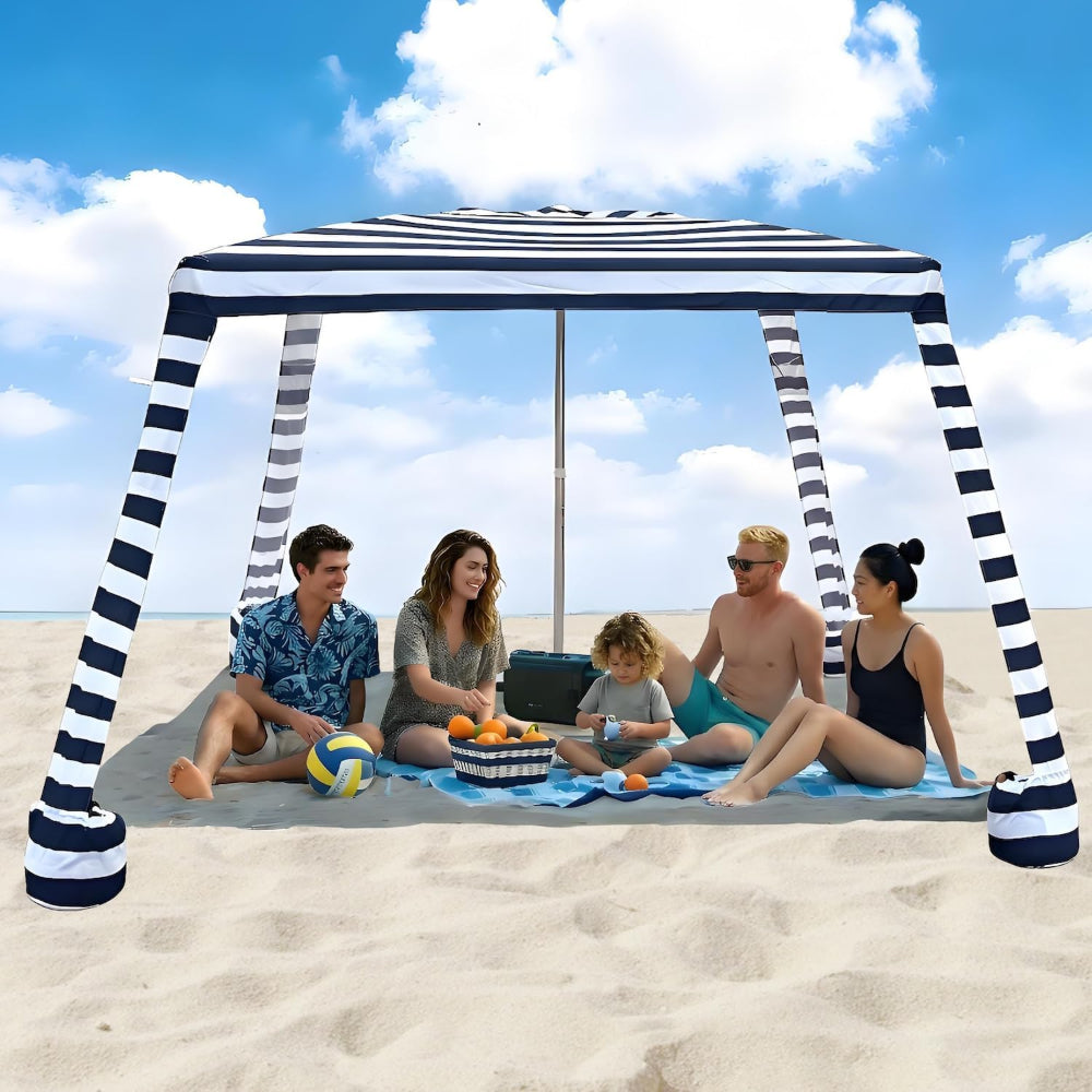 A family of 5 sitting under an AMMSUN 8'x8' navy blue stripes beach tents for family beach cabana