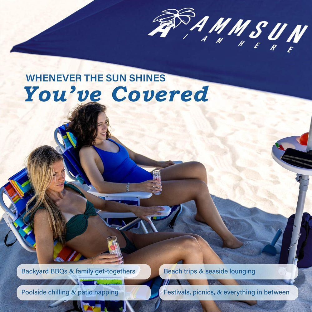 Two women relaxing on beach chairs under a large navy beach umbrellas for sand with sand anchor