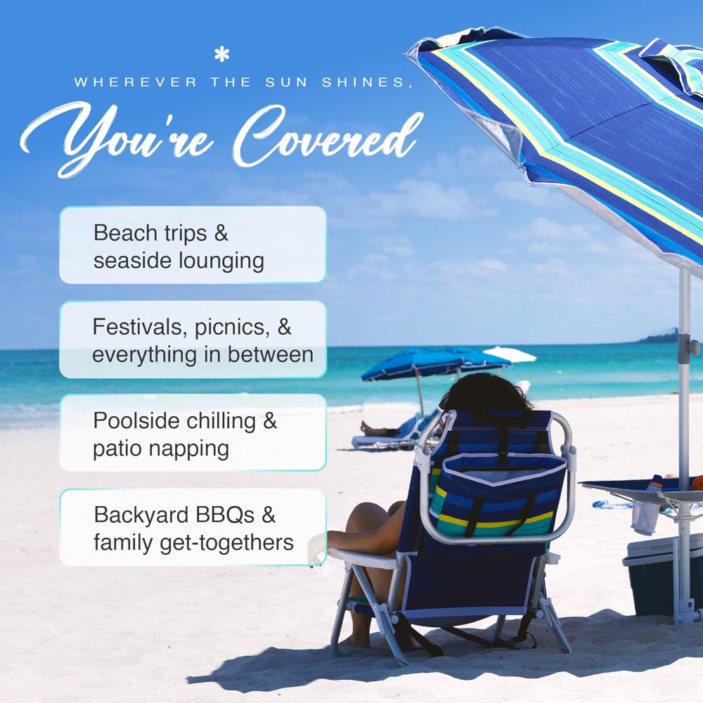 A woman sitting under AMMSUN 7ft blue stripes sun umbrella beach with sand anchor, Built-in Table with UV 50+