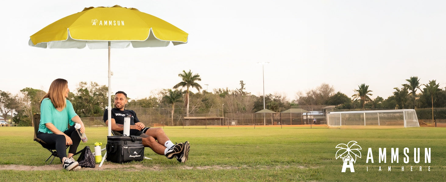 Two people sitting under an AMMSUN 6.5ft portable beach umbrella with tilt outdoor umbrella with base on grass