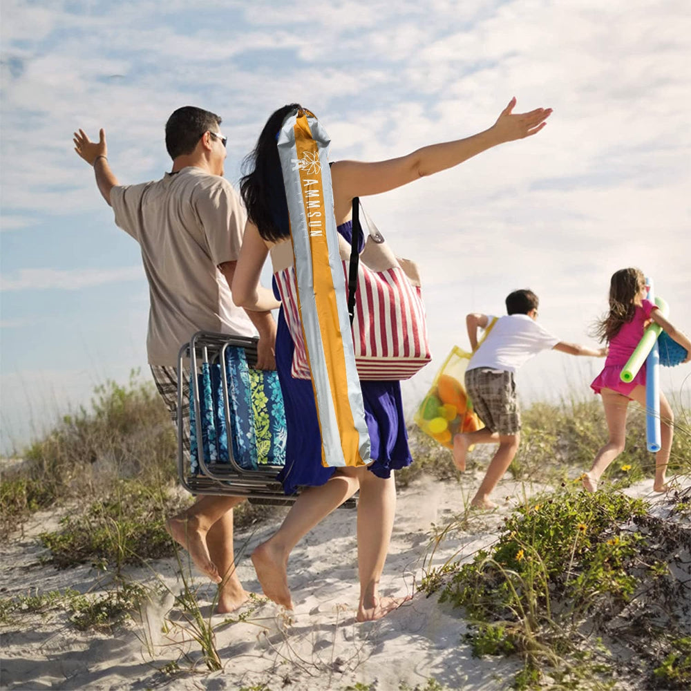 Family walking on a sandy path towards the ocean with AMMSUN 6.5ft portable umbrella for travel with base in carry bag on mom's shoulder