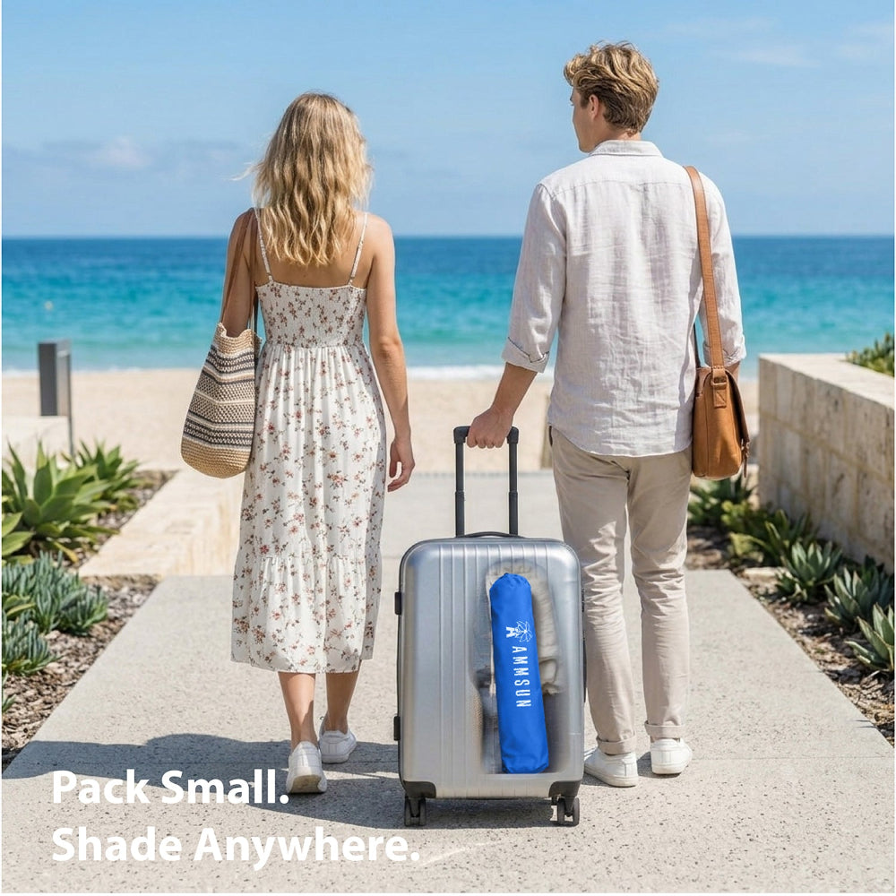 A man and a woman, carrying a suitcase with AMMSUN 6.5ft twice foled portable umbrella with stand in a small pack