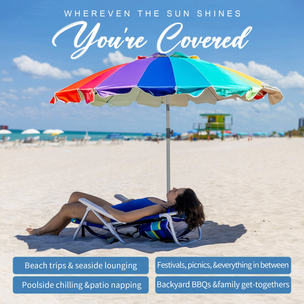 A woman lying beneath AMMSUN 7.5ft rainbow travel beach umbrella with sand anchor on beach