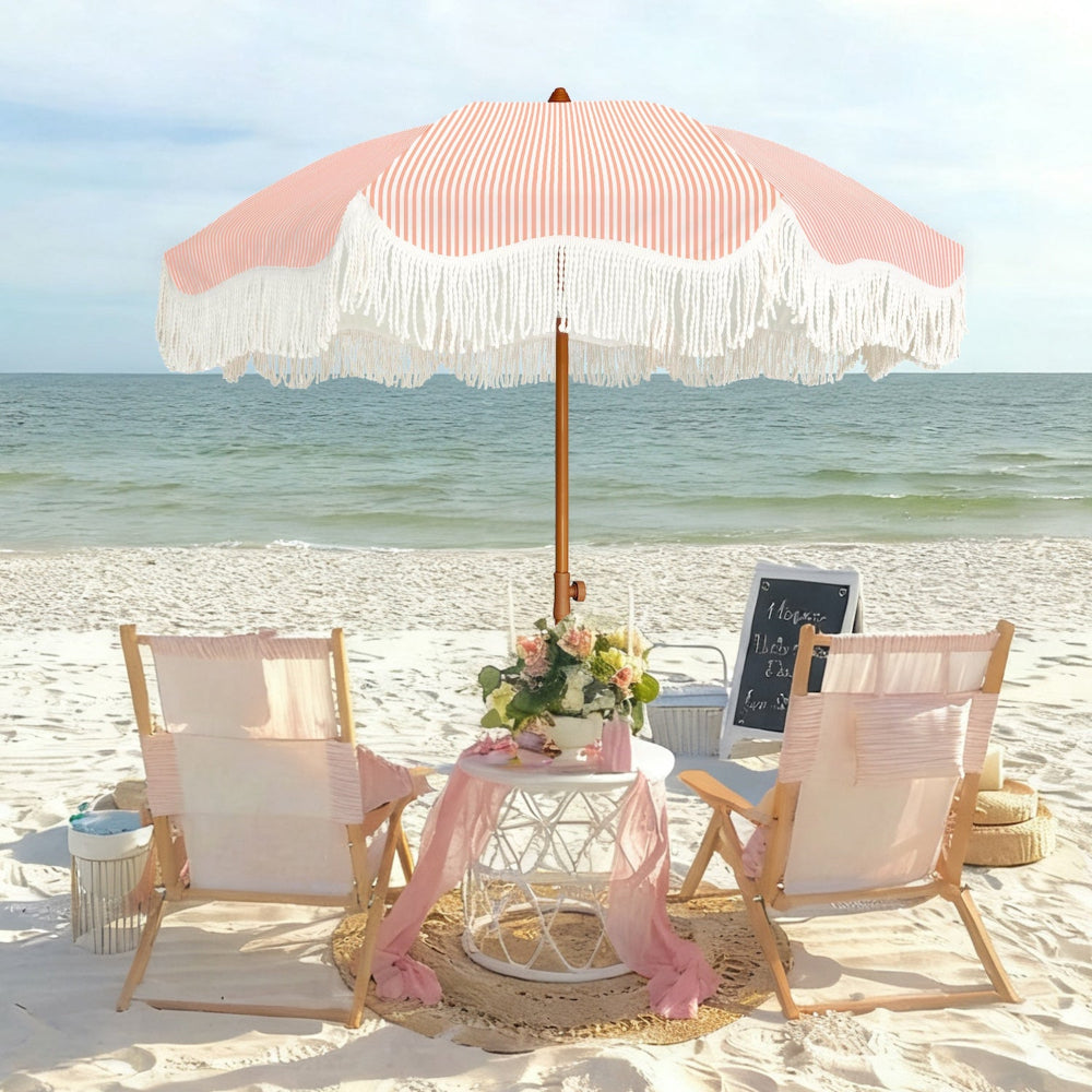 Beach setup with AMMSUN 6.5ft pink stripe boho umbrella outdoor patio with fringe, chairs, and table with flowers