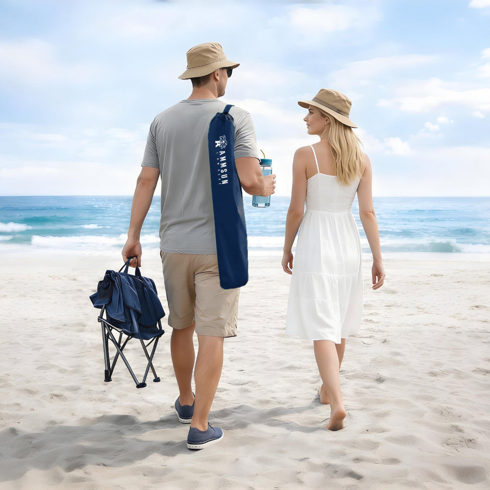 Two people stroll along the beach, carrying a navy blue bag for AMMSUN wheelchair umbrellas with clamp for beach chair
