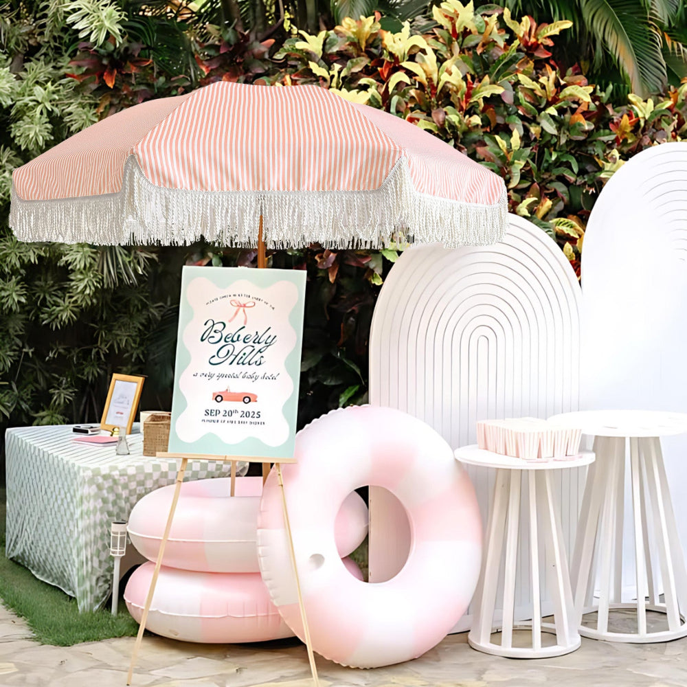 A birthday party setting with an AMMSUN pink outdoor umbrellas for patio with fringe, decorated in an elegant style