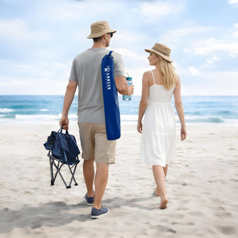 Two people stroll along the beach, carrying a blue bag for AMMSUN wheelchair umbrellas with clamp for beach chair