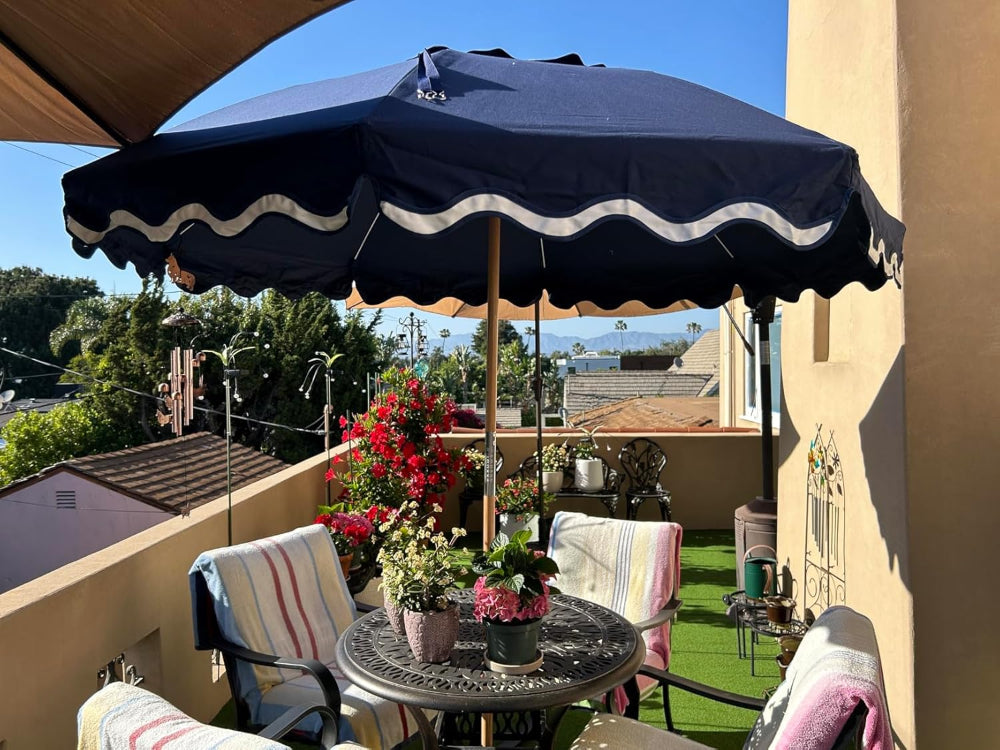 A patio featuring a table and chairs shaded by an AMMSUN large boho patio umbrella