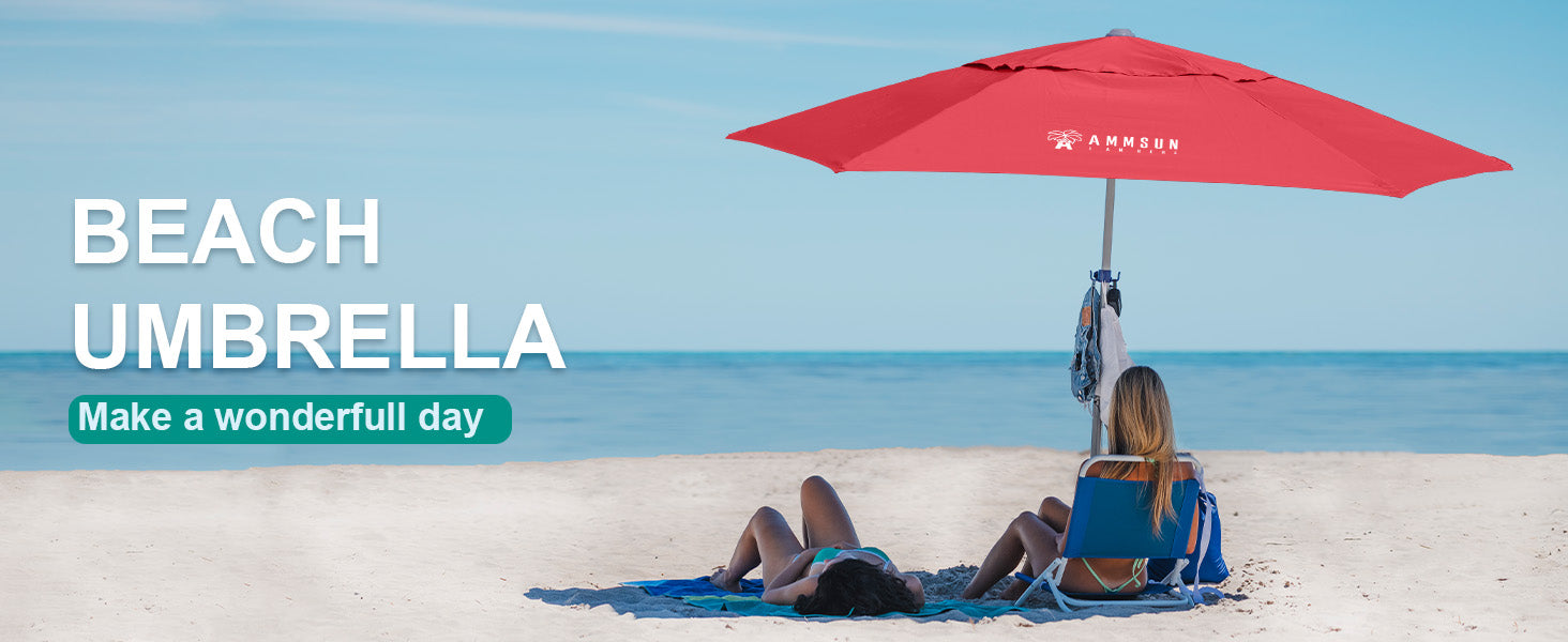 A woman seated under AMMSUN 8ft red large beach umbrella with sand anchor, surrounded by sand and ocean