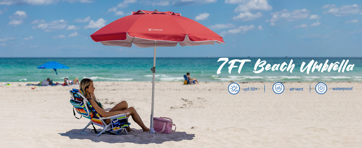 A woman sits peacefully on the beach, sheltered by AMMSUN solid red 7ft beach umbrellas for sand with stand