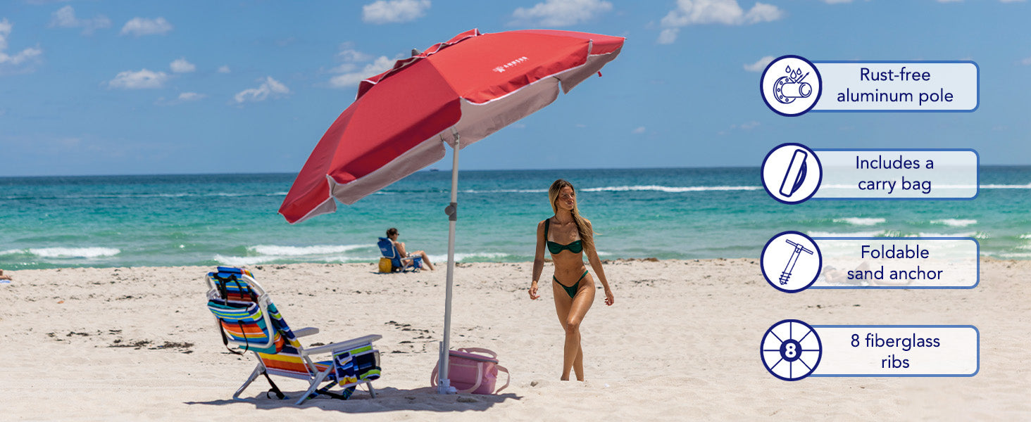 A woman enjoying beach day with AMMSUN solid red 7ft travel beach umbrella with sand anchor